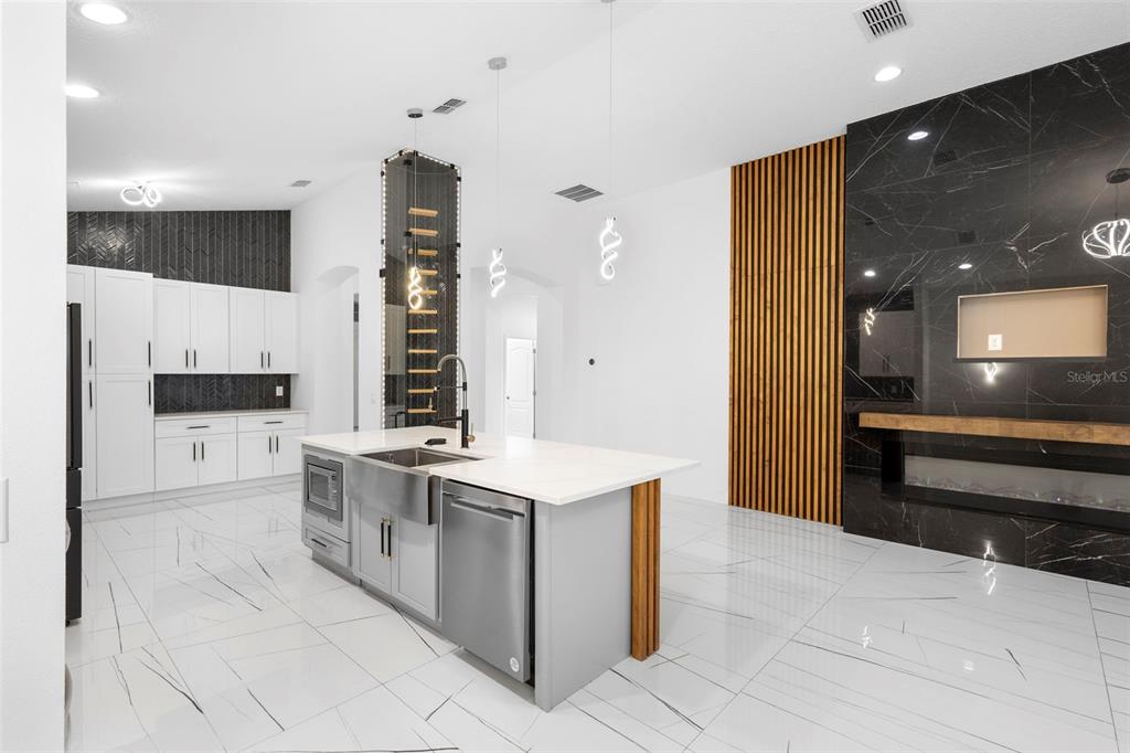 2342 Kaley Ridge Road Clermont, FL 34715 - Photo 20 of 54 a large kitchen with stainless steel appliances a stove and a refrigerator