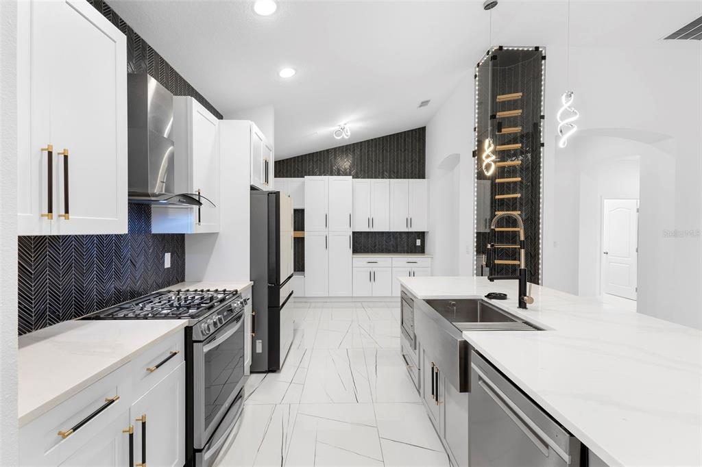 2342 Kaley Ridge Road Clermont, FL 34715 - Photo 21 of 54 a kitchen with stainless steel appliances a sink stove and refrigerator