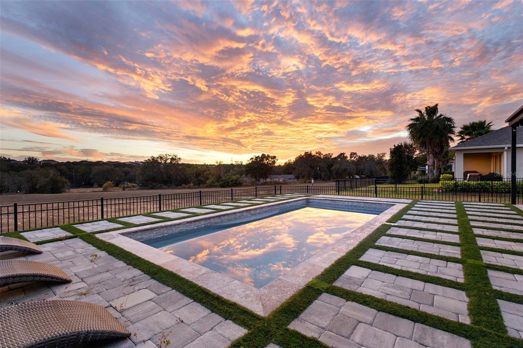 2342 Kaley Ridge Road Clermont, FL 34715 - Photo 25 of 54 a view of a swimming pool with a lounge chair