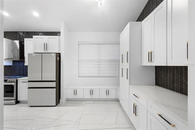 a kitchen with stainless steel appliances a refrigerator stove microwave and cabinets