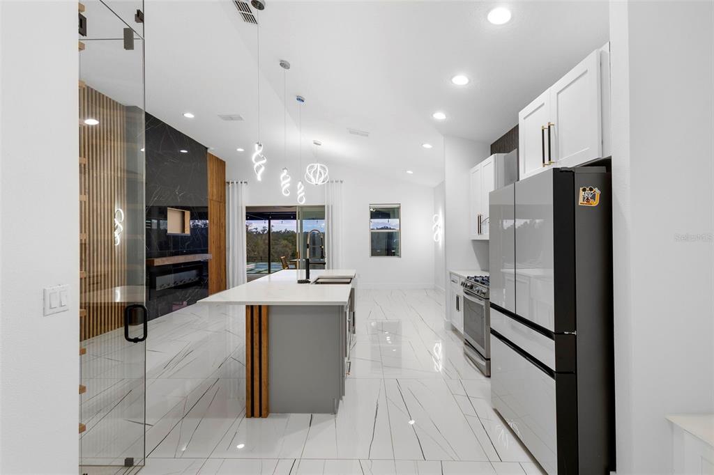 2342 Kaley Ridge Road Clermont, FL 34715 - Photo 27 of 54 a large kitchen with stainless steel appliances lots of counter space and windows