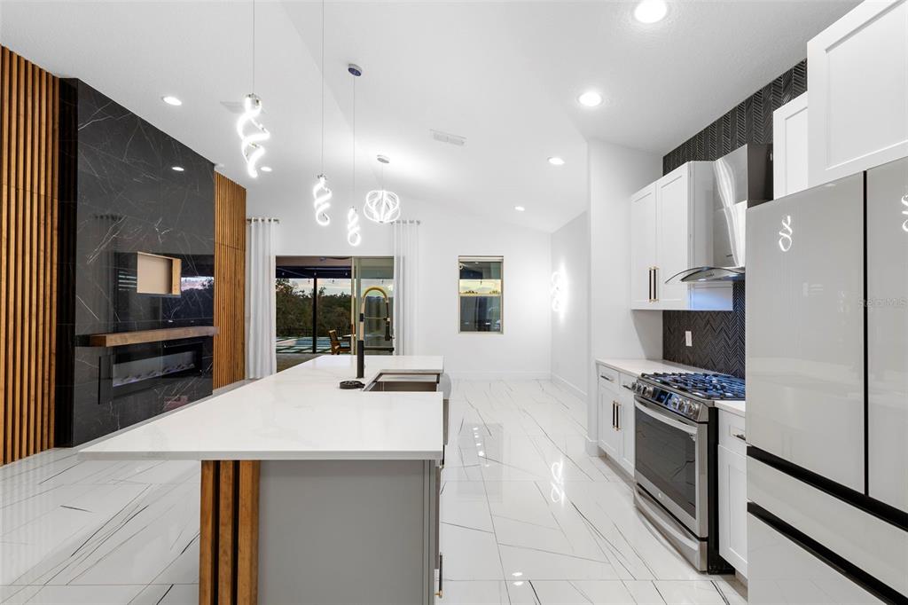 2342 Kaley Ridge Road Clermont, FL 34715 - Photo 30 of 54 a kitchen with stainless steel appliances a refrigerator stove microwave and cabinets