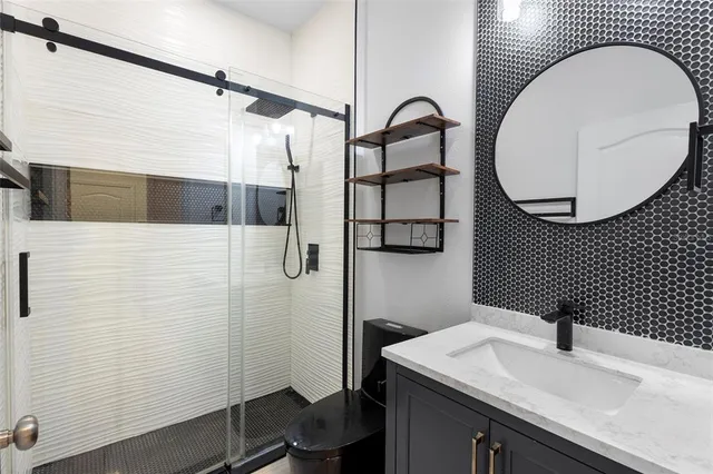 a bathroom with a bathtub sink vanity and mirror