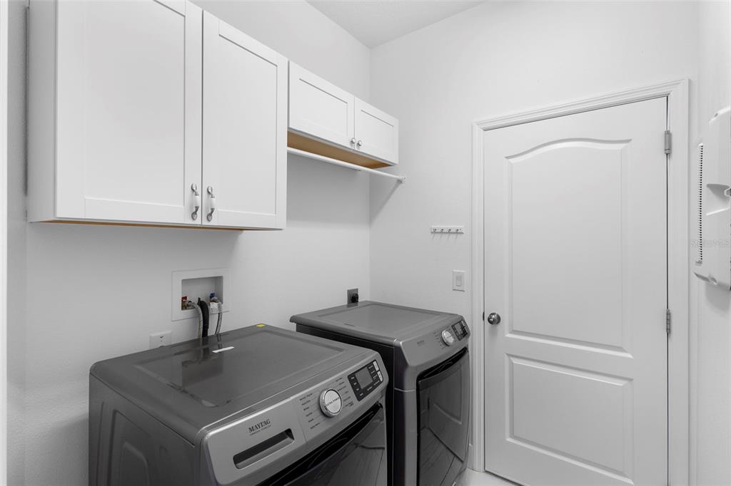 2342 Kaley Ridge Road Clermont, FL 34715 - Photo 36 of 54 a view of a storage and utility room with washer and dryer