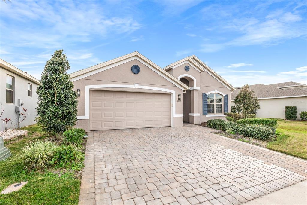 2342 Kaley Ridge Road Clermont, FL 34715 - Photo 4 of 54 a front view of a house with a yard and garage