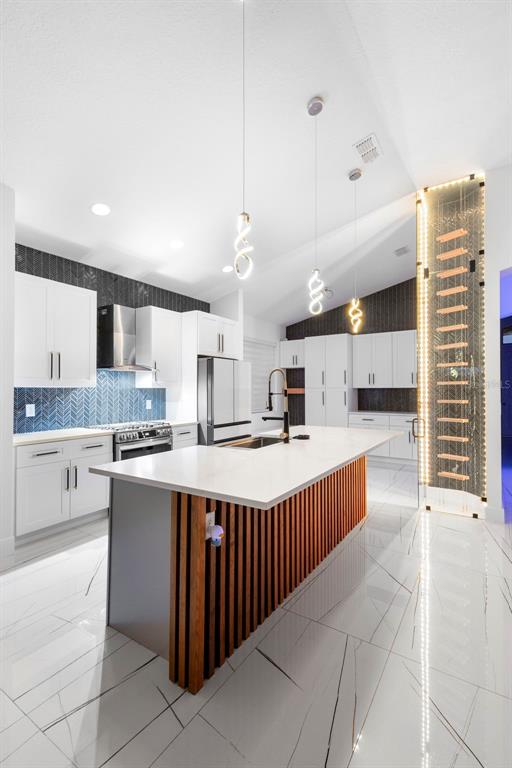 2342 Kaley Ridge Road Clermont, FL 34715 - Photo 43 of 54 a kitchen with stainless steel appliances a sink and cabinets