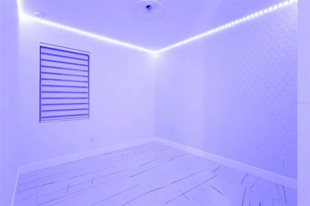 a kitchen with granite countertop a stove a sink and a window