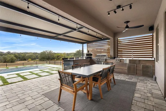 a view of a porch with chairs and floor to ceiling window