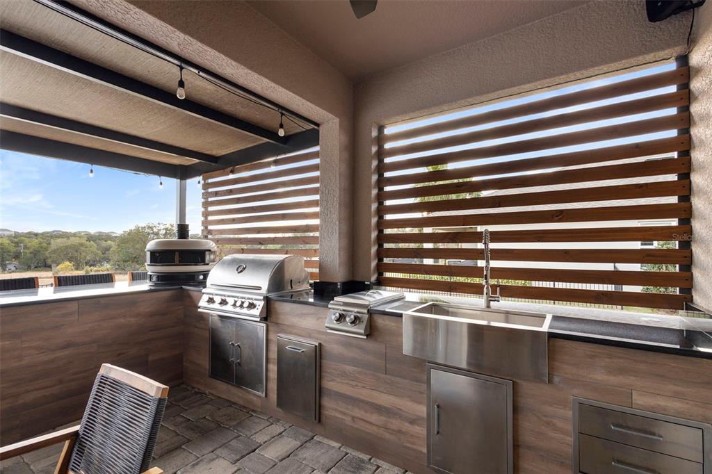 2342 Kaley Ridge Road Clermont, FL 34715 - Photo 48 of 54 a kitchen with granite countertop a stove a sink and a window