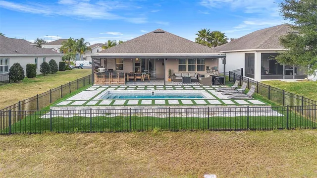 an aerial view of residential houses with outdoor space and parking