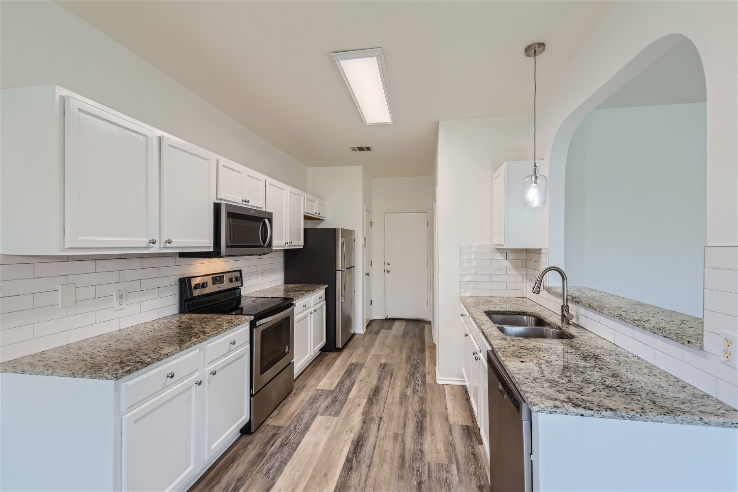115 Killian Loop Hutto, TX 78634 - Photo 3 of 14 Granite counters and stainless steel appliances complete this bright, functional kitchen.