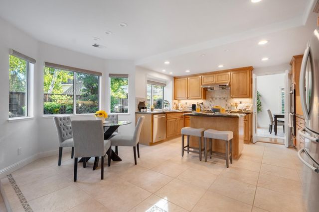 a living room with stainless steel appliances kitchen island granite countertop furniture and a view of kitchen