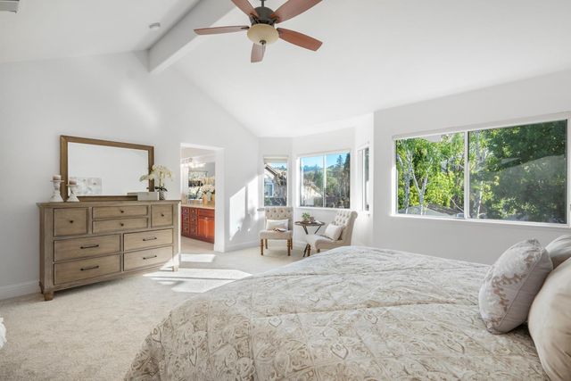 a spacious bedroom with a large bed and a window