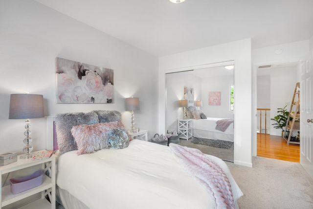 a bedroom with a bed and a large mirror