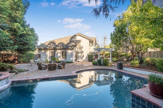 a view of a swimming pool with sitting area