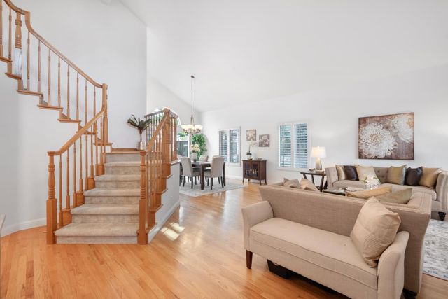 a living room with furniture or stairs and a wooden floor