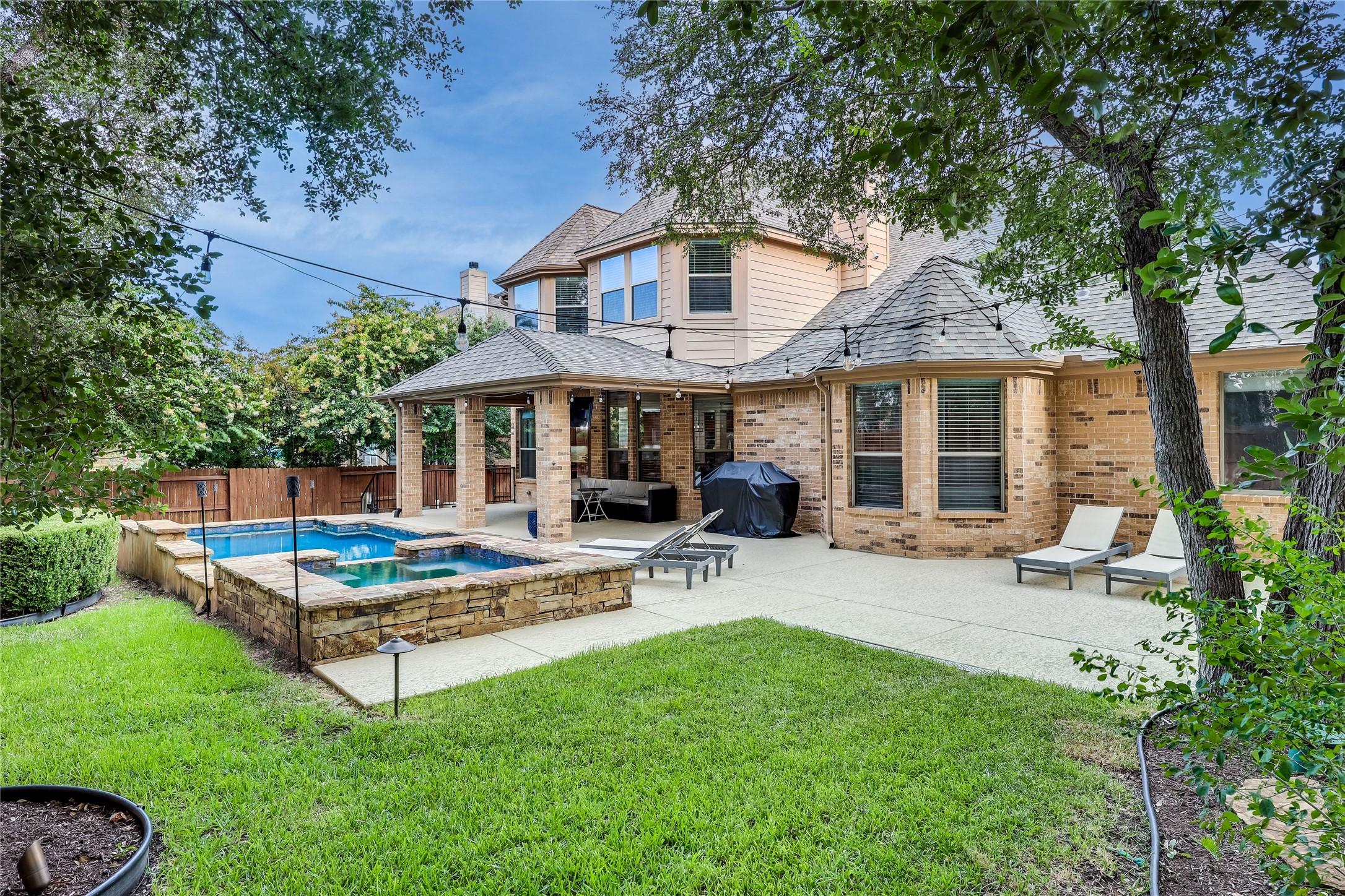 408 Ridgetop Bend Cedar Park, TX 78613 - Photo 37 of 40 An inviting backyard oasis features a glistening pool and spa alongside a spacious patio, perfect for outdoor enjoyment.