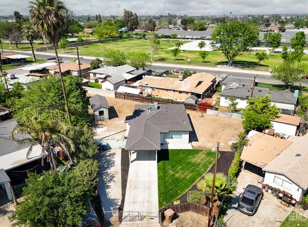 an aerial view of a house with a garden and lake view