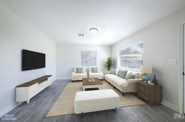 a view of a room with wooden floor and white walls