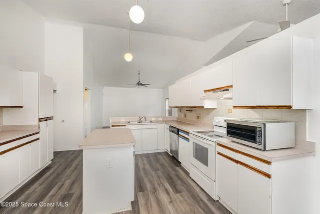 a kitchen with a stove top oven and cabinets