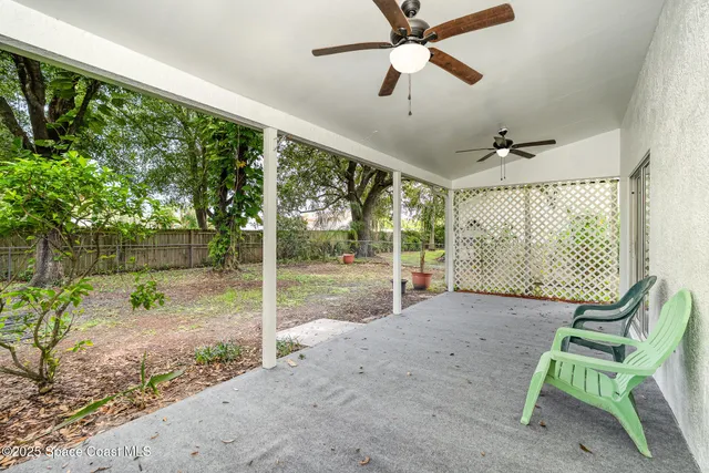 a view of porch with a table and chairs