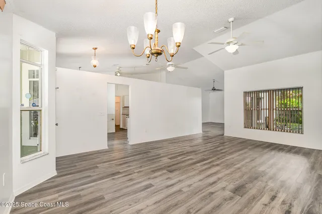 a view of a kitchen with a sink and wooden floor