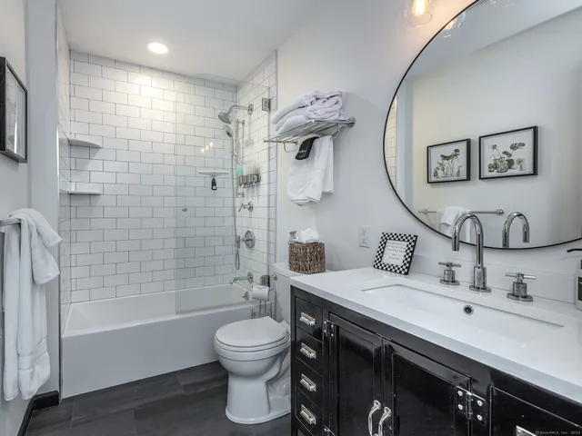 a bathroom with a sink toilet and shower