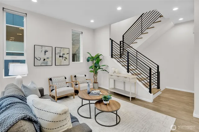 a living room with furniture and wooden floor