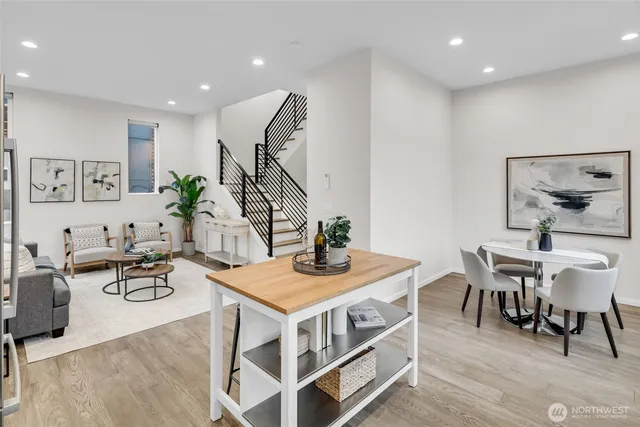 a view of a dining room with furniture wooden floor and a rug