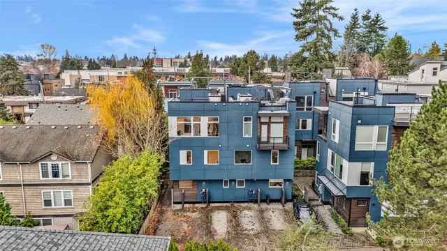 a view of a building in front of residential houses