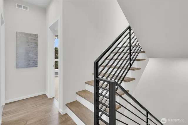 a view of stairs and hall with wooden floor