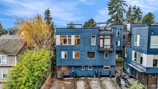 a view of a large building with a tree and windows