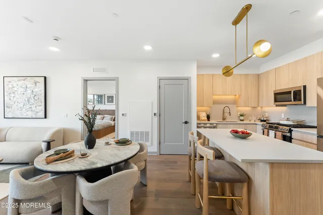 a kitchen with a stove a table and chairs in it