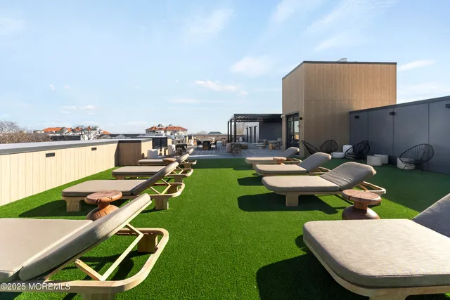 a backyard of a house with table chairs and a fire pit
