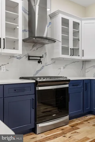 a kitchen with stainless steel appliances granite countertop a stove and a microwave