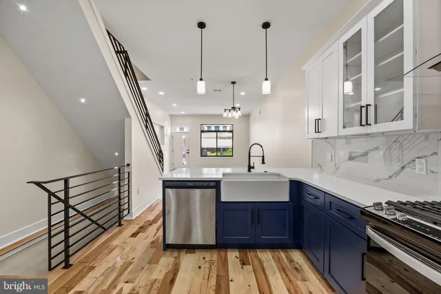 a kitchen with stainless steel appliances granite countertop a sink stove and cabinets