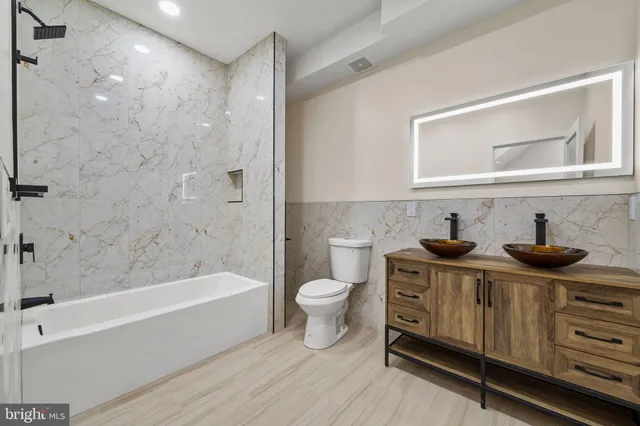 a bathroom with a toilet a sink and bathtub
