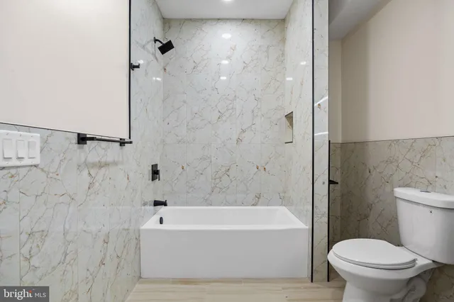 a bathroom with a bathtub and a toilet