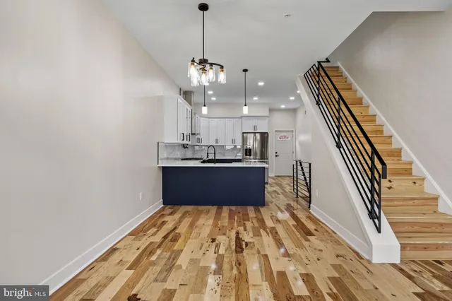 a view of kitchen with sink and wooden floor