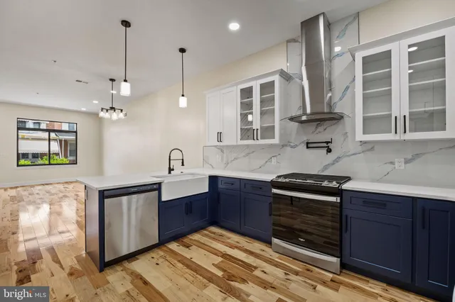 a kitchen with stainless steel appliances granite countertop a stove and cabinets