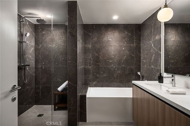 a bathroom with a sink shower and a mirror