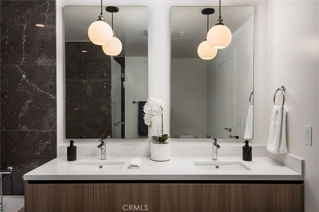 a bathroom with a double vanity sink and a mirror