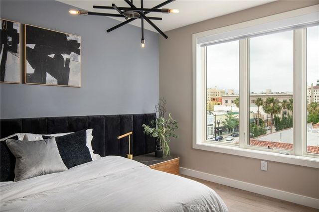 a bedroom with a large bed and a window