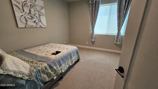 a bedroom with a bed and hallway