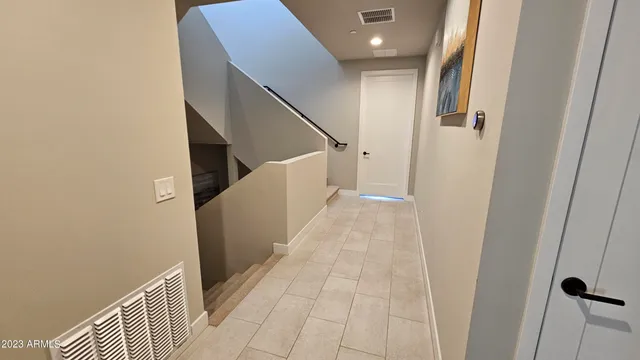 a large bed sitting in a bedroom next to a window