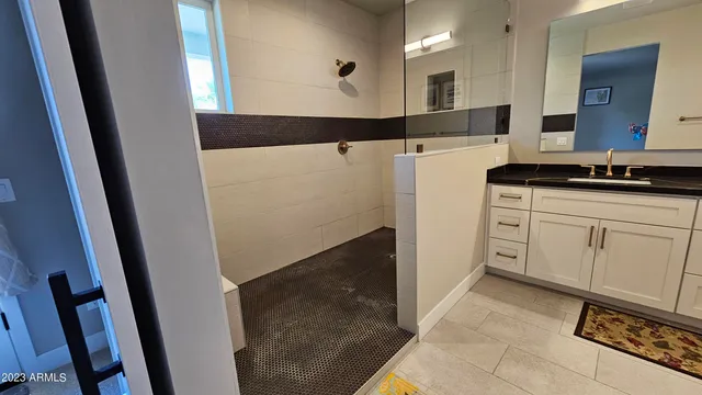 a bathroom with a double vanity sink and mirror