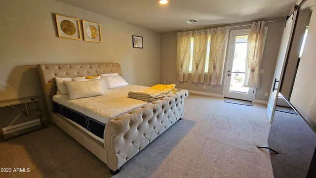 a large bed sitting in a room next to a window