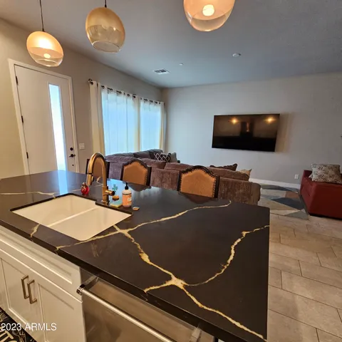 a living room with a flat screen tv and a large window