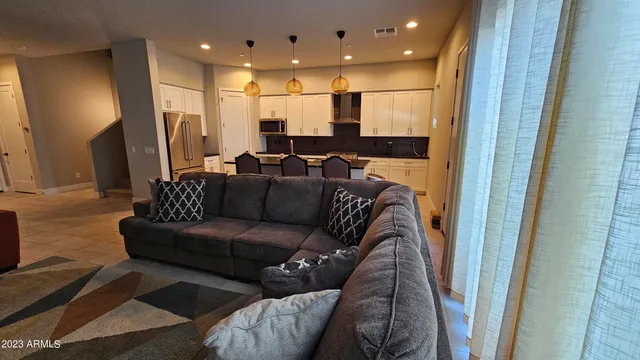 a living room with furniture and a glass door