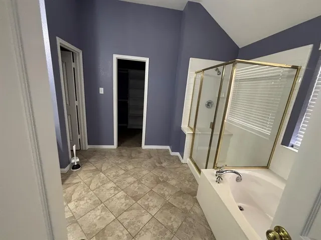 a bathroom with a tub and a shower